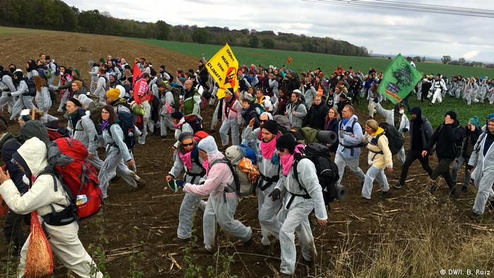 Protesters cross a field during a massive protest against coal in western Germany