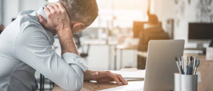 Employee with neck strain as a result of using an incorrectly set up workstation